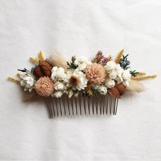 a hair comb decorated with flowers and feathers