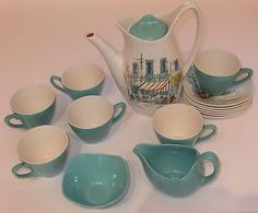 a tea set with cups and saucers on a table