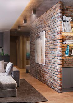 a living room filled with furniture and a brick wall behind the couch is a bookshelf