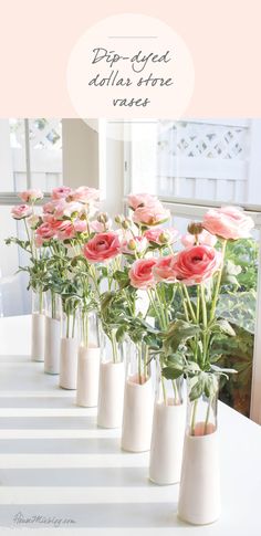 pink flowers in vases sitting on a table