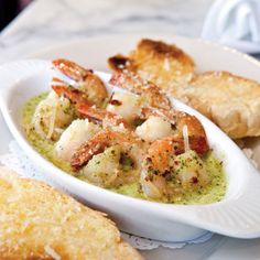 a white plate topped with shrimp and bread