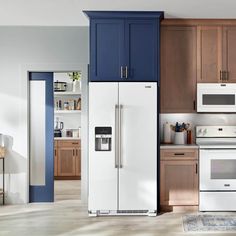 a white refrigerator freezer sitting inside of a kitchen next to wooden cupboards and cabinets