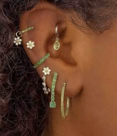 a close up of a person's ear with three different types of piercings