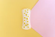 A sanitary pad with chamomile flowers on... | Premium Photo #Freepik #photo #certificate #woman #medical #white Sanitary Pads Product Photography, Colorful Background, Chamomile Flowers, Yellow Background, Premium Photo, Blue Backgrounds, Photography Ideas