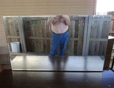 a man standing in front of a mirror with his shirt off