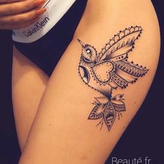 a woman's thigh with an owl tattoo on it