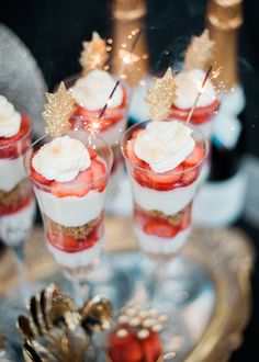 small desserts with strawberries and whipped cream on top