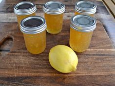 six jars of lemonade sit on a cutting board