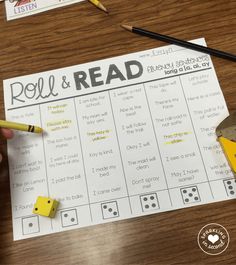 roll and read game with pencils on the table next to it, which includes two dice