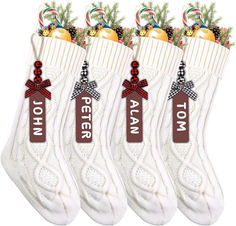 three white socks with red bows and personalized name tags on them, all decorated with candy canes