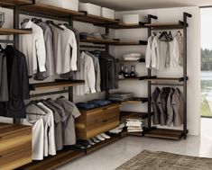 an image of a closet with clothes on shelves and drawers in the middle, next to a rug