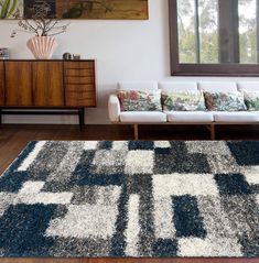 a living room filled with furniture and a rug