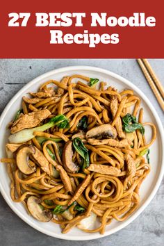 noodles with mushrooms and spinach in a white bowl next to chopsticks on the side