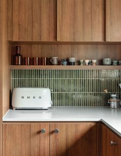 a toaster sitting on top of a kitchen counter next to a microwave and cabinets