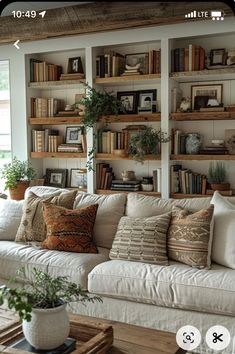 a living room filled with lots of furniture and bookshelves on top of each other