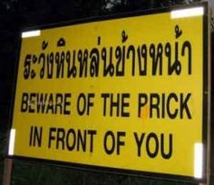 a yellow sign that says beware of the prick in front of you