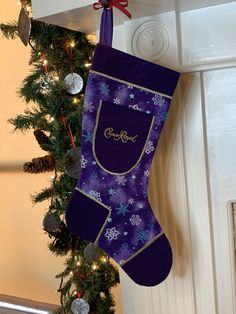 a purple christmas stocking hanging from a door