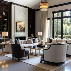 a living room filled with lots of furniture next to a large window covered in curtains