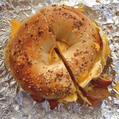 an egg and cheese bagel sandwich on aluminum foil