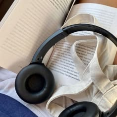 an open book with headphones on top of it