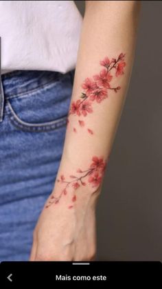 a woman's arm with red flowers on it and the words mais como est