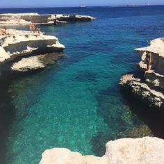 people are swimming in the clear blue water