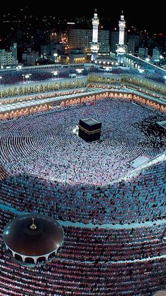 an aerial view of the ka'bah at night, with many people around it