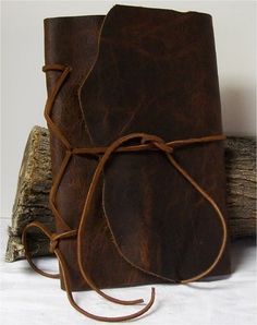 a brown leather book with a rope tied around it