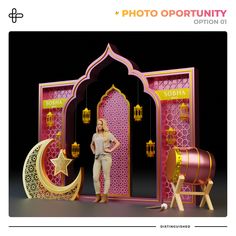 a woman is standing in front of a pink and gold display with an open door