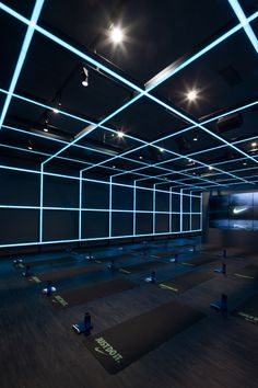 an empty room with blue lights and yoga mats