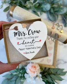 someone is holding up a heart shaped box with the message,'mrs crow makes for valentine's day '