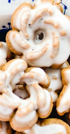 a bowl filled with glazed donuts covered in icing