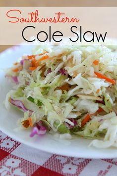 a white plate topped with coleslaw on top of a red and white table cloth