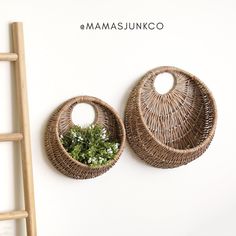 two wicker baskets are hanging on the wall