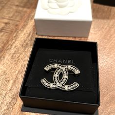 Preowned. In Original Box. Excellent Condition. Limited Edition Chanel Brooch. 6 Pearls And 38 Rhinestones. Luxury White Gold Brooches With Diamond Accents, Classic White Diamond Brooches, Luxury Diamond Brooches In White Gold, Luxury Diamond White Brooch As Gift, Luxury White Gold Diamond Brooches, Classic White Brooches For Evening, Luxury Diamond White Brooches For Anniversary, Classic White Evening Brooches, Luxury Crystal Embellished Jewelry As Gift