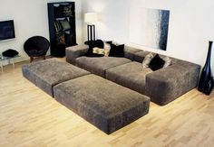 a living room filled with furniture on top of a hard wood floored flooring