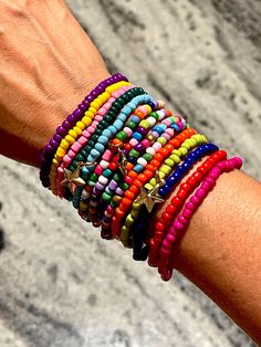 a person's arm with colorful bracelets on it