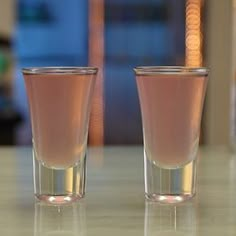 two shot glasses sitting on top of a table