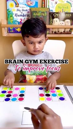 a little boy sitting at a table with a board game in front of him and the words brain gym exercise to improve focus