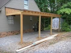 a house with a covered patio in front of it and a shed next to it