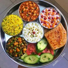 a metal bowl filled with different types of food