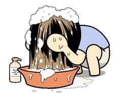 a woman washing her hair in a bowl