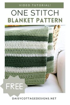 a green and white crocheted blanket sitting on top of a couch next to a basket