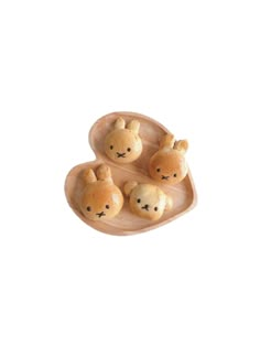 three small teddy bears sitting on top of a wooden tray with two smaller ones in the middle