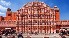 an ornate building with people walking around it