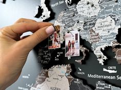 a person is holding up a map with pictures on it and the words mediterranean sea