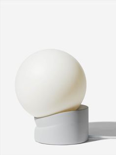 an egg sitting on top of a white base