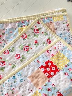 two quilts are laying on the floor next to each other, one has a flowered design