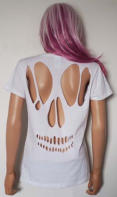 a female mannequin with pink hair wearing a white t - shirt that has cutouts on it