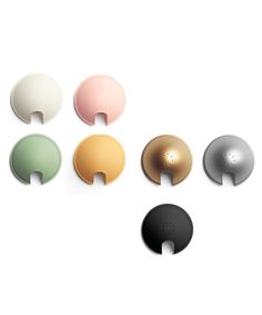 four different colors of knobs on a white surface